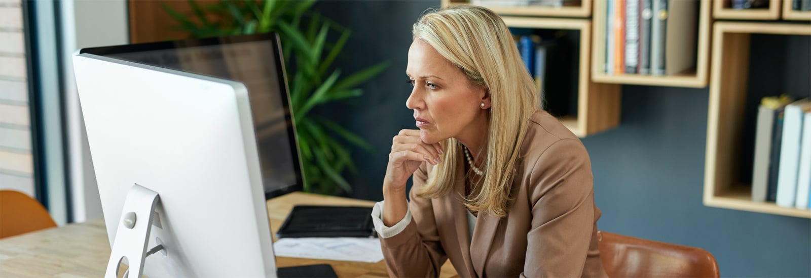 Employee in an office, looking at monitor