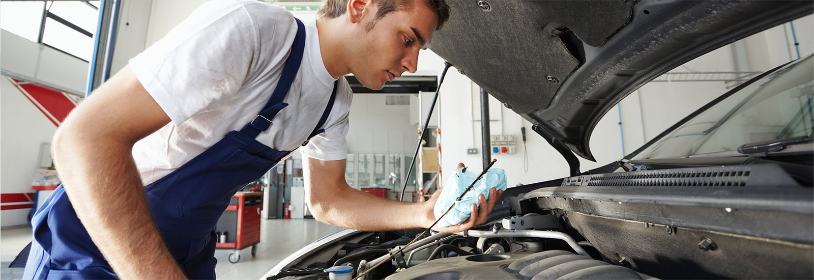 Mechanic looking under the hood of a car