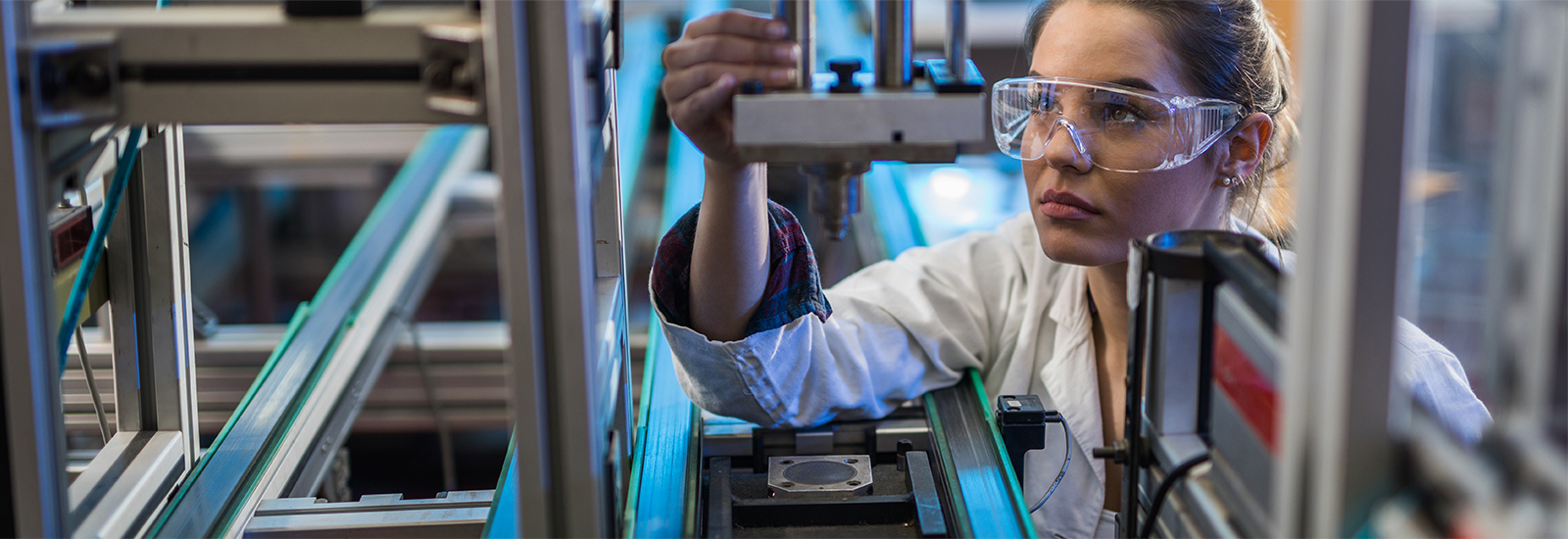 Factory worker operating a machine