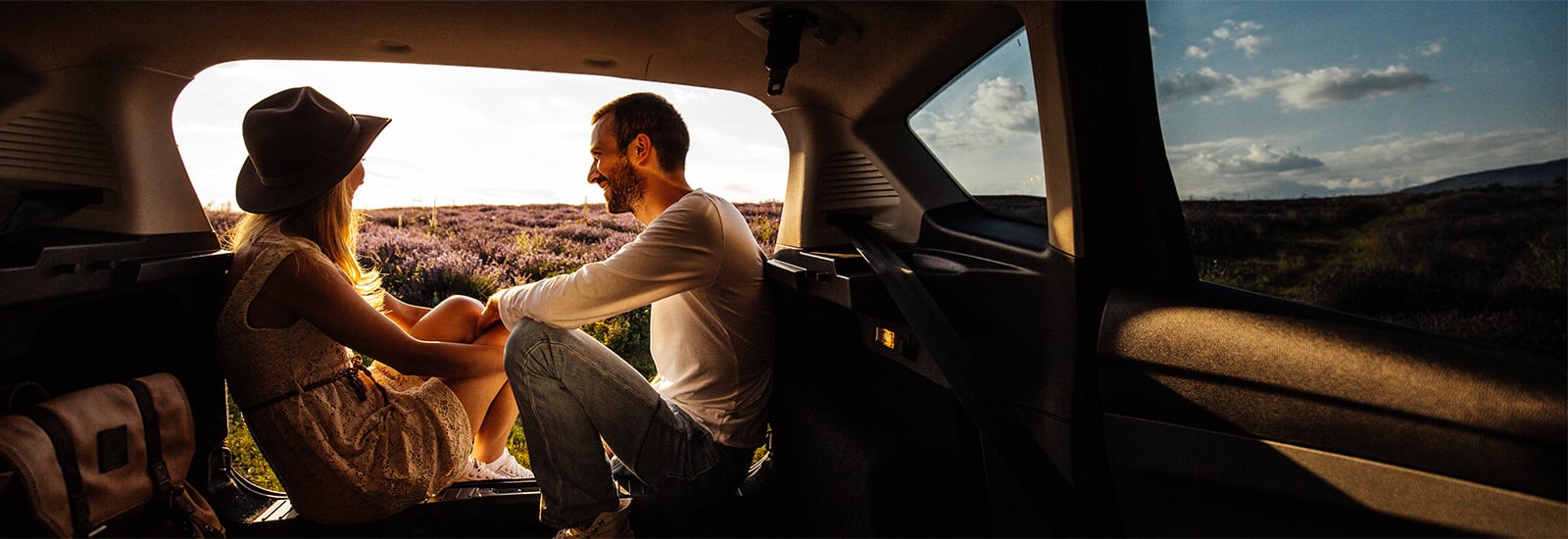 married couple sitting in a van