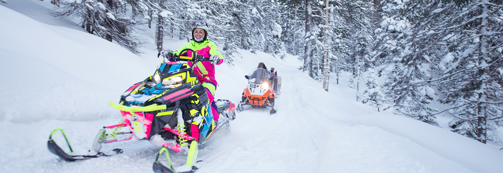 two snowmobiles in the snow